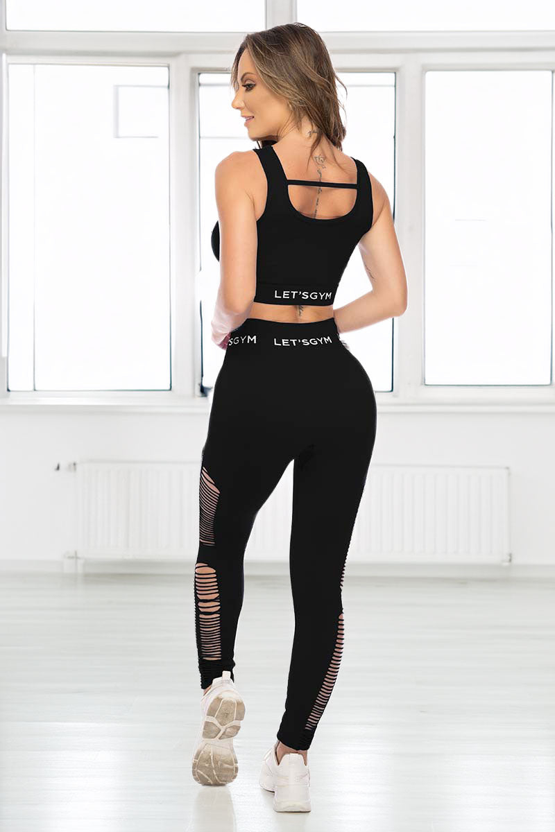 Back view of a Woman wearing a black athletic outfit with &