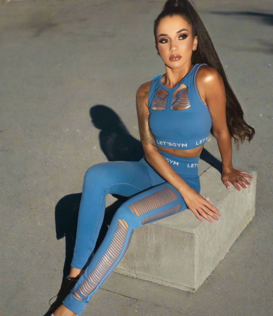 Girl sitting wearing a blue Emana Anti cellulite fabric legging and bra top.