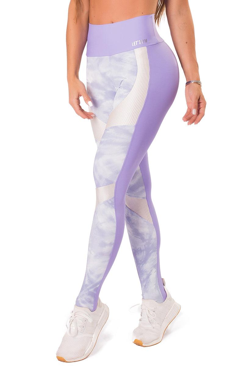 A pair of workout leggings with a high waist, featuring a lilac print on the front and a solid purple color on the back, with white ribbed trim at the waist.