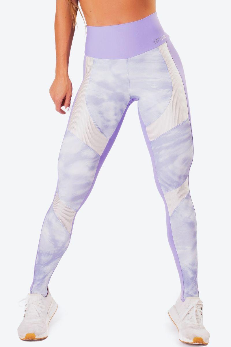 A pair of workout leggings with a high waist, featuring a lilac print on the front and a solid purple color on the back, with white ribbed trim at the waist.