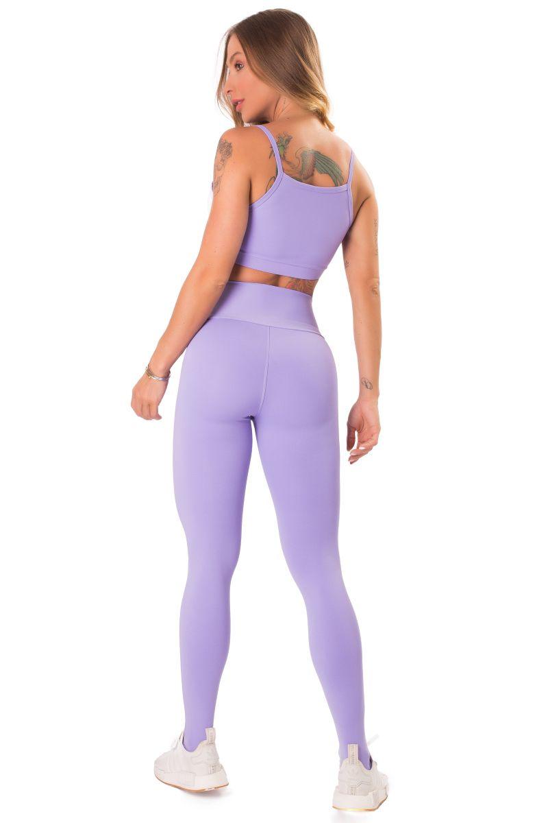 back view of a A pair of workout leggings with a high waist, featuring a lilac print on the front and a solid purple color on the back, with white ribbed trim at the waist.