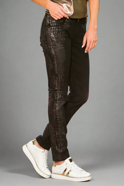 model wearing black python embossed jeans with white and gold tennis shoes 