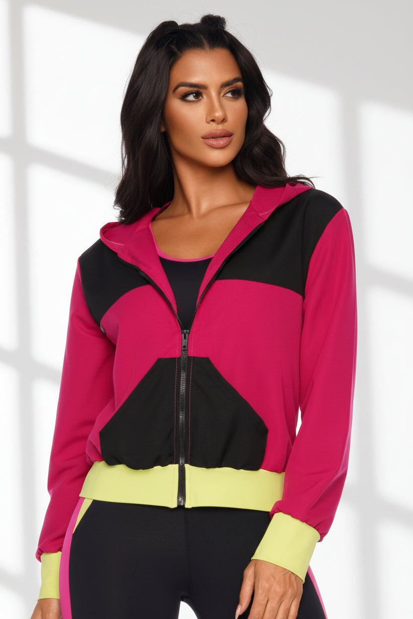 woman wearing a color block jacket in pink and black. 