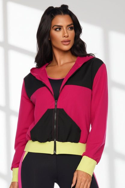 woman wearing a color block jacket in pink and black. 