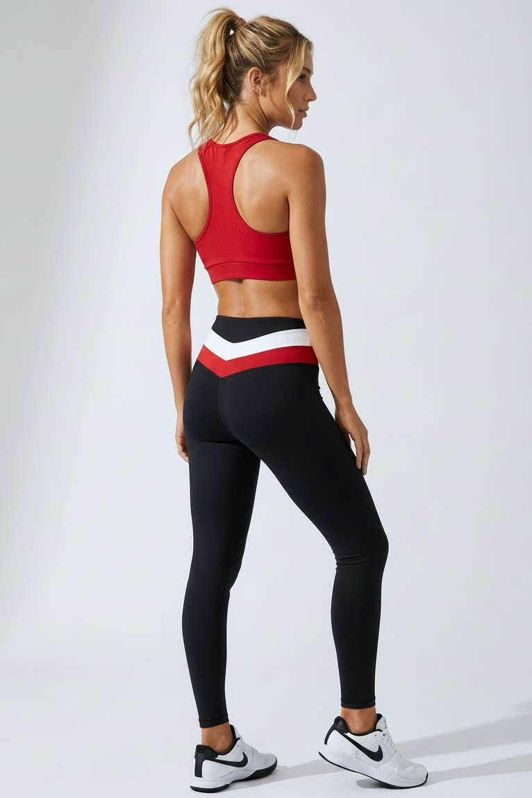 Full-length back view of model wearing red OxyFit Stepping Out Bra and black leggings with white and red waistband.