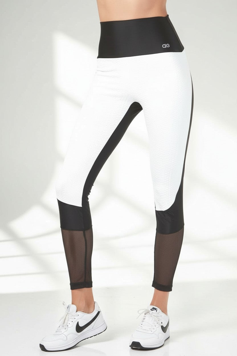 white python embossed supplex with black solid and mesh trim legging. 
