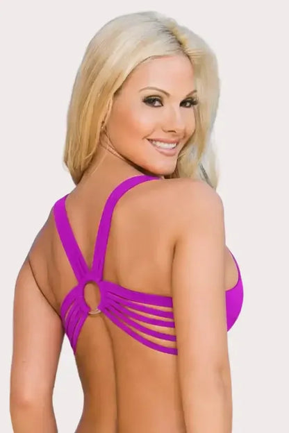 Blonde woman smiling, wearing a purple strappy back sports bra with ring detail